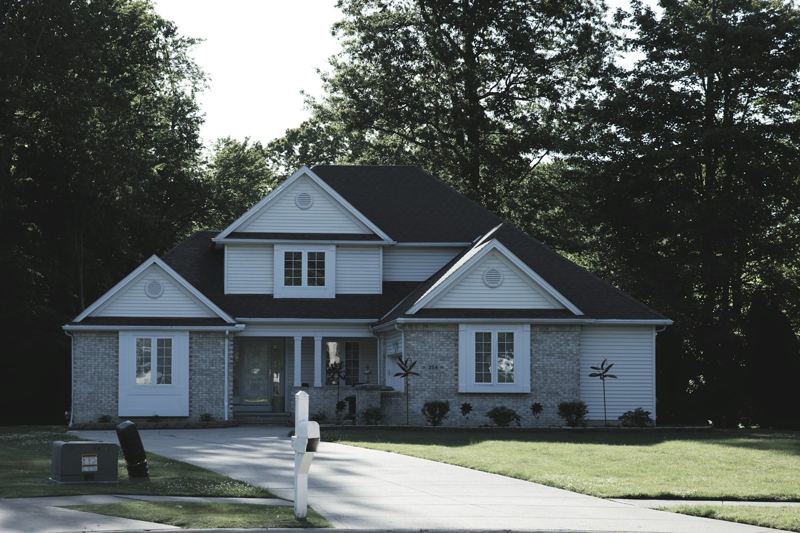 A welcoming home framed by mature trees and a green lawn